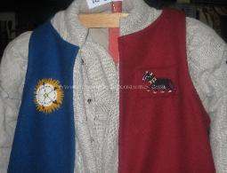 Detail of a livery coat of the Clarence Household, showing hand sewn badges